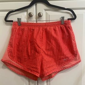 Women’s Nike running shorts dri fit size medium coral pink and orange color